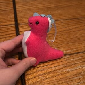 Plush pink dinosaur ornament